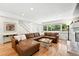 Spacious living room featuring hardwood floors, a large window, and a comfortable sofa, perfect for relaxing at 11880 W 30Th Pl, Lakewood, CO 80215