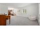 Large, open living room with plush carpet, large windows for natural light, and a view of the front yard at 11880 W 30Th Pl, Lakewood, CO 80215