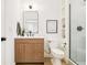 Stylish bathroom featuring wood vanity, modern fixtures, and a glass-enclosed shower at 2736 N Clay St, Denver, CO 80211