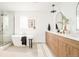Spa-like bathroom featuring a modern soaking tub, double vanities, and stylish fixtures at 2736 N Clay St, Denver, CO 80211