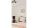 Comfortable chair and wooden table with decorative items inside a neutral bedroom space at 2736 N Clay St, Denver, CO 80211