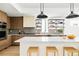 This modern kitchen showcases sleek wood cabinetry, stainless steel appliances, and a spacious marble countertop island at 2736 N Clay St, Denver, CO 80211