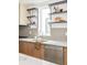 Modern kitchen with stainless steel appliances, stylish backsplash, and sleek wood cabinetry at 2736 N Clay St, Denver, CO 80211