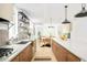 Open-concept kitchen with stainless steel appliances, stylish backsplash, a large island and easy access to the dining area at 2736 N Clay St, Denver, CO 80211