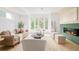Bright living room featuring large windows, modern decor, a stylish fireplace, and comfortable seating arrangements at 2736 N Clay St, Denver, CO 80211