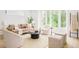 Bright and airy living room featuring a sofa, armchairs, and a large window at 2736 N Clay St, Denver, CO 80211