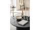 Close-up on black coffee table with candles, book, and wine displaying modern living room at 2736 N Clay St, Denver, CO 80211