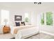 Bright and airy main bedroom featuring large windows, a queen-sized bed, and stylish décor at 2736 N Clay St, Denver, CO 80211