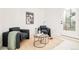 Inviting sitting room boasts cozy armchairs and elegant marble tables at 2736 N Clay St, Denver, CO 80211