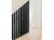 Modern staircase with vertical metal slats and light wood flooring creates an airy, minimalist design at 2736 N Clay St, Denver, CO 80211