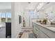 Modern bathroom featuring double vanity, large mirror, and a glass enclosed shower at 14952 Gladshine Dr, Parker, CO 80134