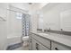 Bright bathroom with modern vanity, large mirror, and a shower with blue floral curtain at 14952 Gladshine Dr, Parker, CO 80134