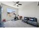 Bedroom featuring ceiling fan, window view, exercise bike, and cozy gray seating at 14952 Gladshine Dr, Parker, CO 80134