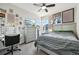 Bedroom with gray furniture, a large bed, a desk with vanity, and window views at 14952 Gladshine Dr, Parker, CO 80134