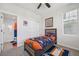 Cozy bedroom boasts a full bathroom, closet, a twin bed with a Denver Broncos theme and ceiling fan at 14952 Gladshine Dr, Parker, CO 80134