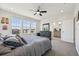 Bright bedroom boasts large windows, ceiling fan, and ensuite bathroom access at 14952 Gladshine Dr, Parker, CO 80134