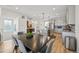 Open concept dining room with contemporary lighting and staircase access at 14952 Gladshine Dr, Parker, CO 80134