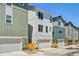 Stylish townhome exteriors with a mix of muted colors and well-maintained front yards at 14952 Gladshine Dr, Parker, CO 80134