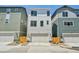 Modern townhome featuring a clean white exterior and a two-car garage at 14952 Gladshine Dr, Parker, CO 80134