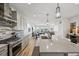 Modern kitchen featuring a large island with gray cabinets and stone countertops at 14952 Gladshine Dr, Parker, CO 80134