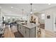 Open-concept kitchen with large island, seating, and access to the living area at 14952 Gladshine Dr, Parker, CO 80134