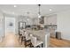Bright kitchen with modern island, pendant lighting, and stainless steel appliances at 14952 Gladshine Dr, Parker, CO 80134