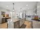 Modern kitchen island featuring a stainless dishwasher and overhead lighting at 14952 Gladshine Dr, Parker, CO 80134