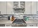 Modern kitchen island with gray cabinets, stainless appliances, and barstool seating at 14952 Gladshine Dr, Parker, CO 80134