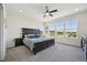 Spacious main bedroom featuring a ceiling fan, three windows, and a large bed at 14952 Gladshine Dr, Parker, CO 80134