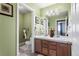 Bright bathroom with double sinks, wood cabinets, tile floors, and ample counter space at 8559 W 93Rd W Ct, Broomfield, CO 80021