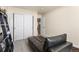 This bedroom has a black leather daybed and closet for storage at 8559 W 93Rd W Ct, Broomfield, CO 80021