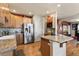 Spacious kitchen boasts stainless steel appliances, granite counters, light wood cabinetry, and hardwood floors at 8559 W 93Rd W Ct, Broomfield, CO 80021