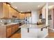 Kitchen featuring stainless steel appliances, granite counters, a mosaic backsplash, and light wood cabinetry at 8559 W 93Rd W Ct, Broomfield, CO 80021