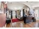 Bright living room with hardwood floors, a fireplace, and access to the bar area at 8559 W 93Rd W Ct, Broomfield, CO 80021