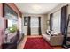 Comfortable living room featuring hardwood floors, a plush red rug and natural light at 8559 W 93Rd W Ct, Broomfield, CO 80021