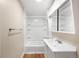 Updated bathroom featuring a tub shower, single sink vanity, and modern fixtures at 10505 Lowry Pl, Aurora, CO 80010