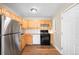 Well-lit kitchen with wood cabinets, modern appliances, and ample counter space at 10505 Lowry Pl, Aurora, CO 80010