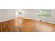 Open living room featuring hardwood floors and large windows for natural light at 10505 Lowry Pl, Aurora, CO 80010
