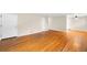 Spacious living room with polished hardwood floors and fresh paint at 10505 Lowry Pl, Aurora, CO 80010