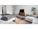 Bright bedroom features a cozy bed with soft textures and a large television at 5211 Routt Ct, Arvada, CO 80002