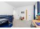 Bright bedroom featuring a bunk bed, neutral carpet, and natural light from the window at 5211 Routt Ct, Arvada, CO 80002