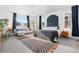 Sun-drenched main bedroom boasts a plush bed, seating area, and stylish decor for ultimate relaxation at 5211 Routt Ct, Arvada, CO 80002