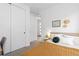 Bright bedroom featuring a large bed, minimalist decor, and access to a hallway, promoting a tidy space at 5211 Routt Ct, Arvada, CO 80002