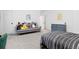 Bedroom with grey sofa covered in stuffed animals and modern decor at 5211 Routt Ct, Arvada, CO 80002
