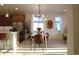 Contemporary dining room adjacent to kitchen, featuring hardwood floors and modern lighting at 5211 Routt Ct, Arvada, CO 80002