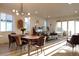 Open concept living and dining area with large windows, stylish furnishings, and abundant light at 5211 Routt Ct, Arvada, CO 80002