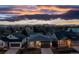 Charming single-Gathering home featuring a well-maintained lawn, attached garage, and picturesque sunset backdrop at 5211 Routt Ct, Arvada, CO 80002