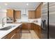Beautiful kitchen featuring stainless steel appliances, quartz countertops, and custom cabinets at 5211 Routt Ct, Arvada, CO 80002