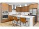 Modern kitchen featuring a stainless steel range hood, ample counter space, and a breakfast bar at 5211 Routt Ct, Arvada, CO 80002
