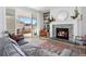Cozy living room featuring a stone fireplace, comfortable seating, and bright natural light at 5211 Routt Ct, Arvada, CO 80002